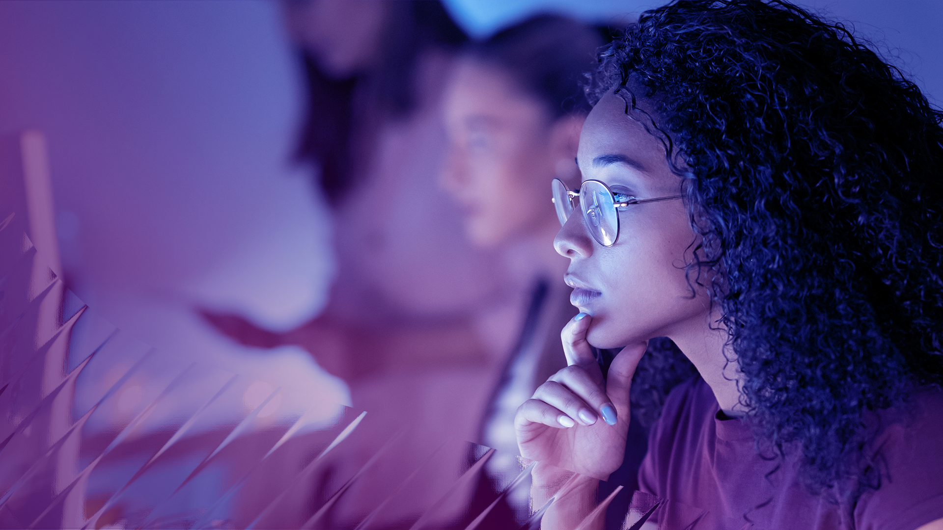 Image of a woman looking at a monitor screen.