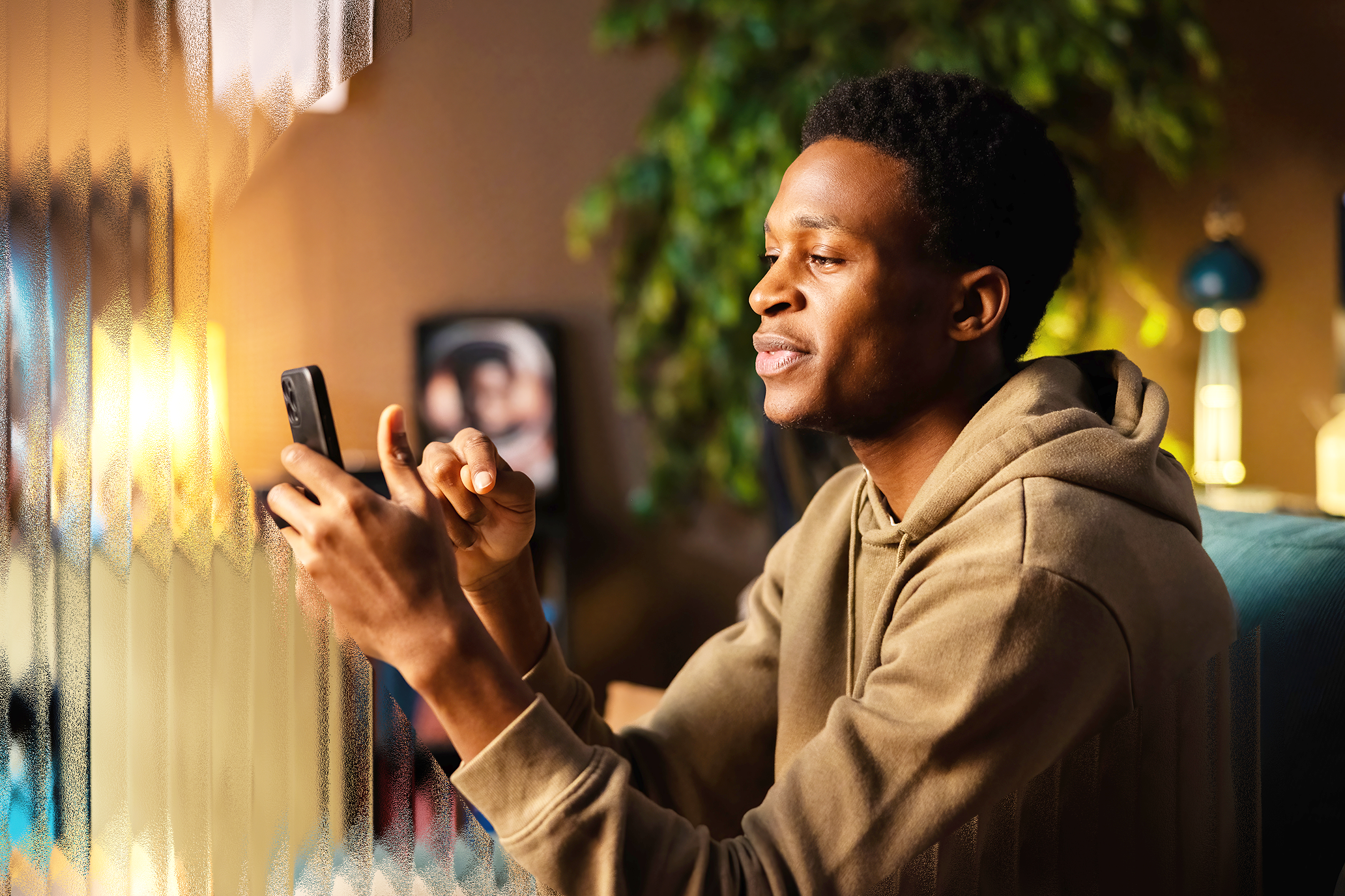Image of a young man on his phone.