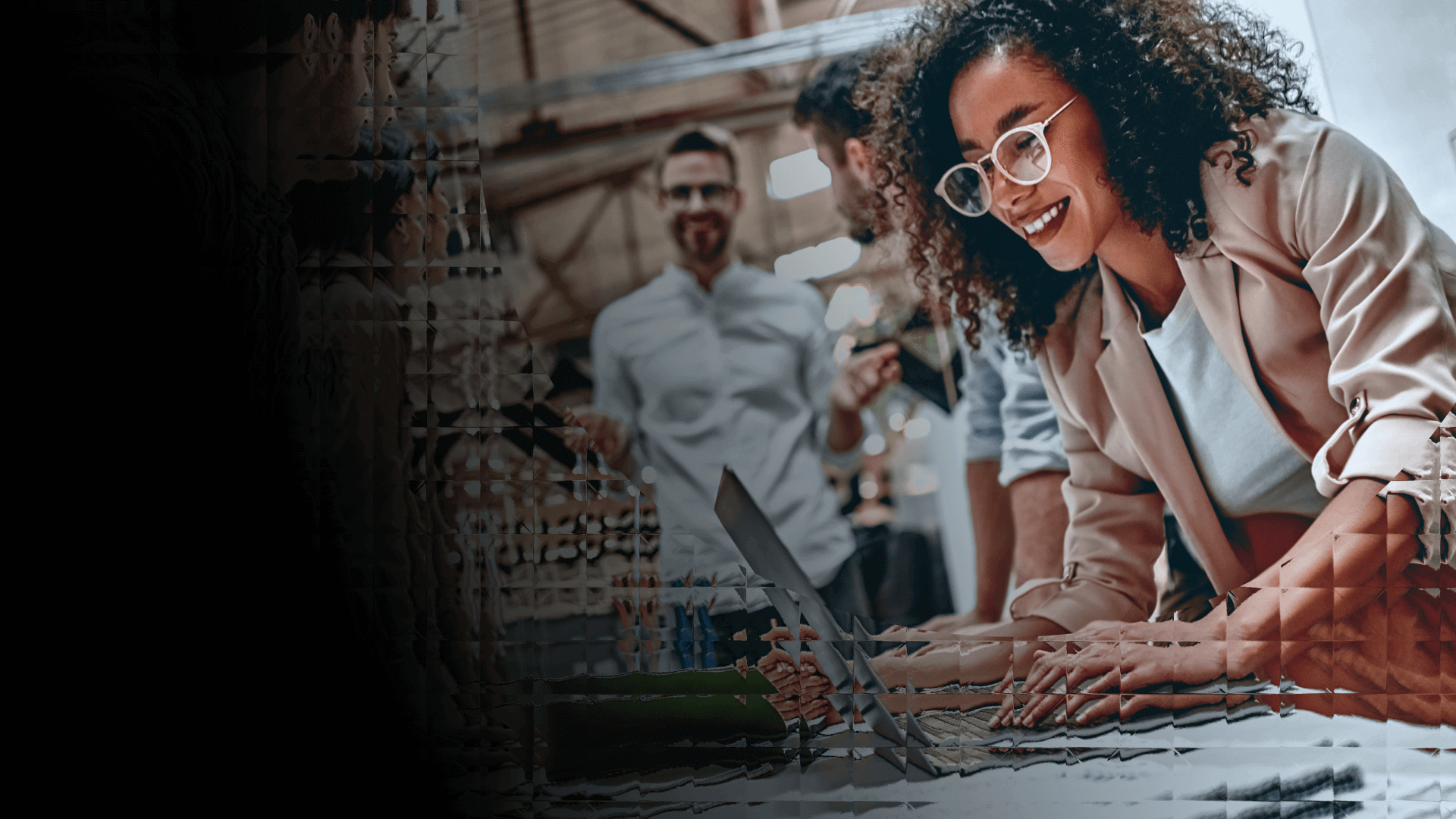 A woman working with some excited coworkers in a high-energy office environment