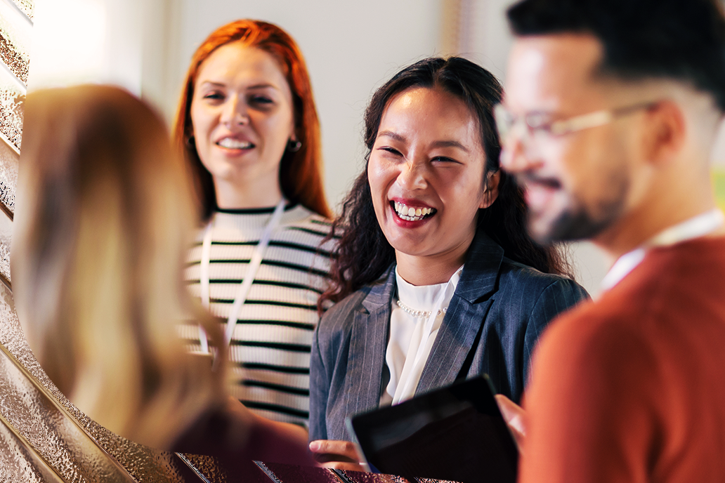 Image of a smiling happy woman with her colleagues