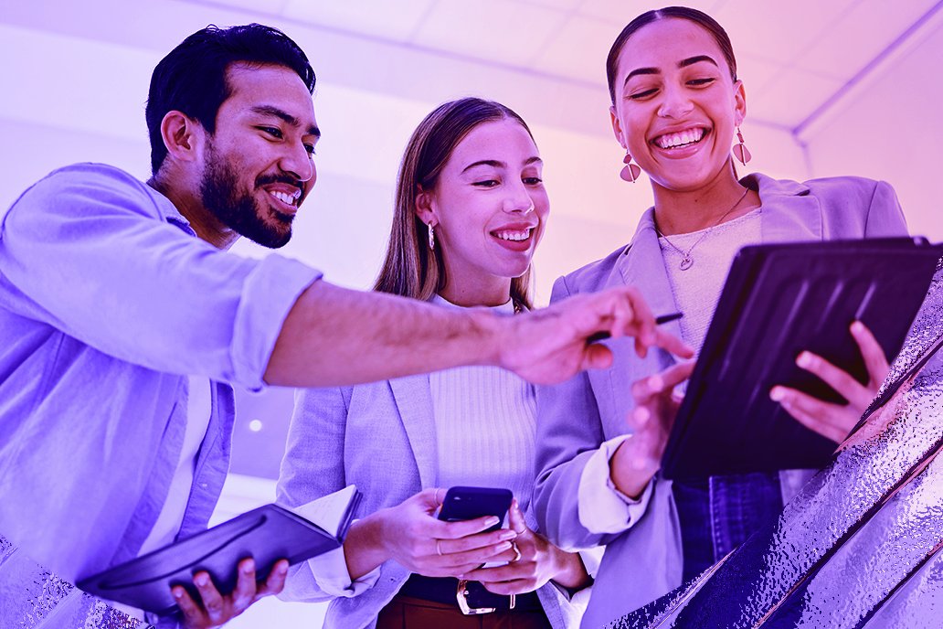 Image of a team working together looking at a tablet