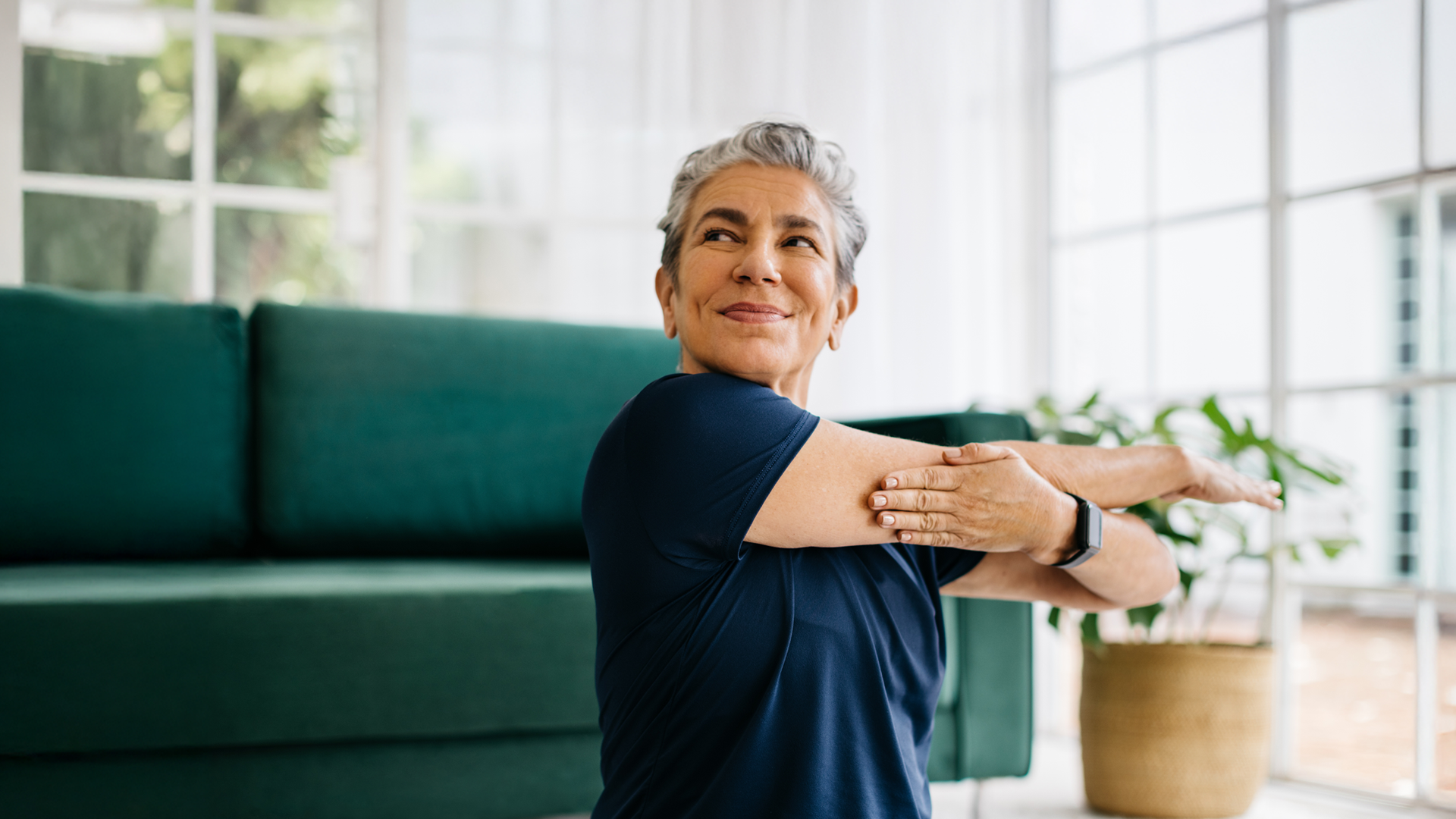 Image of a woman stretching her arms to the side